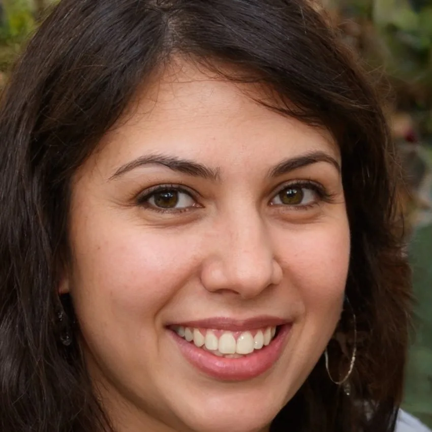 Close-up image of Emma Carter smiling outdoors.