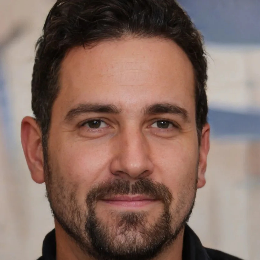 Close-up portrait of Michael Turner with a confident expression and neatly groomed beard.