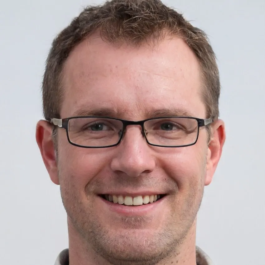 Portrait of Liam Harris, a man with glasses and a warm, friendly smile.